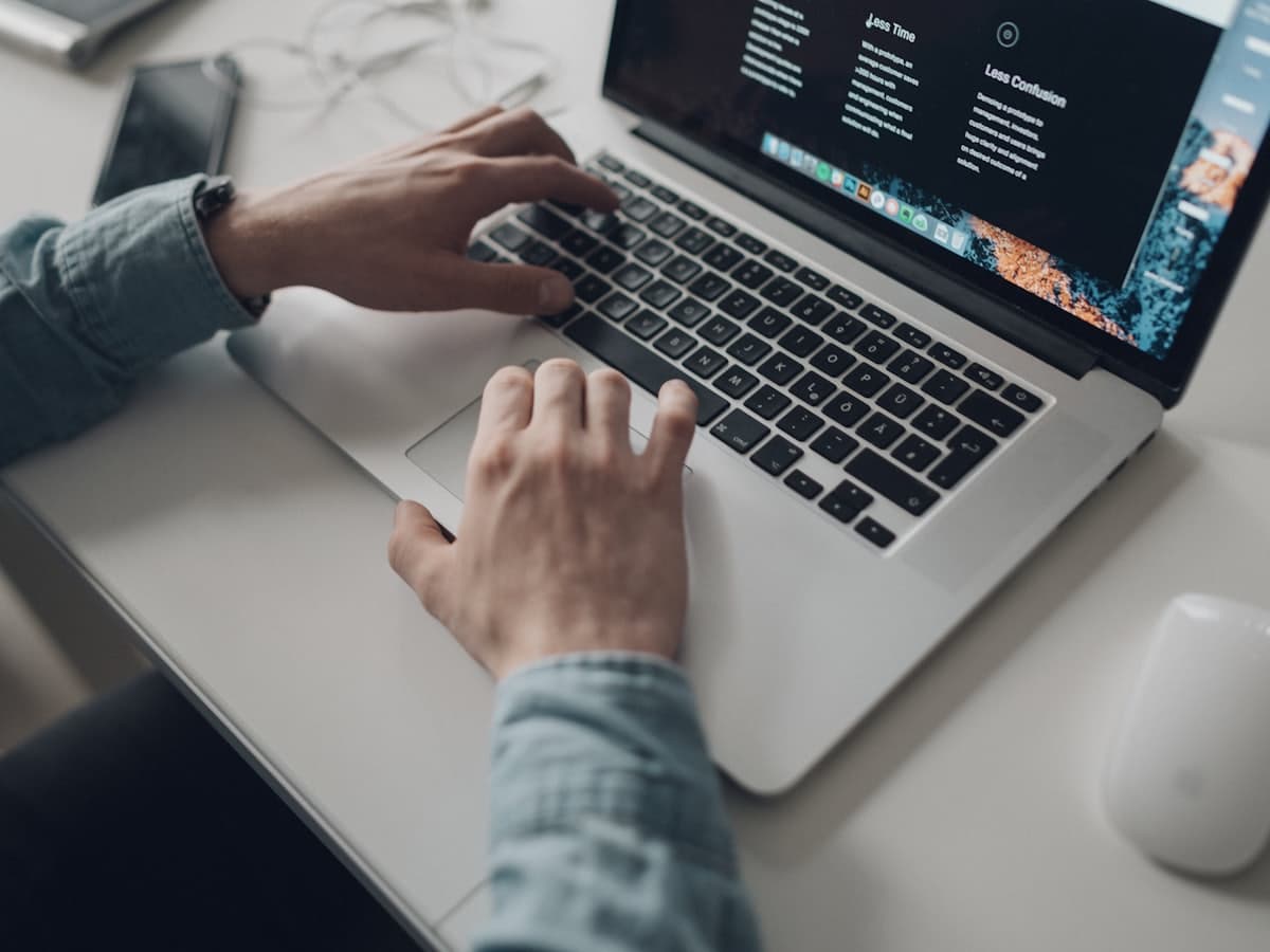 Placeholder cover. Hands typing on a laptop showing a minimal interface.